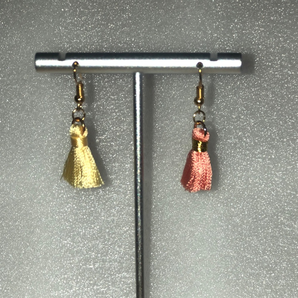 Pink and yellow tassels on gold